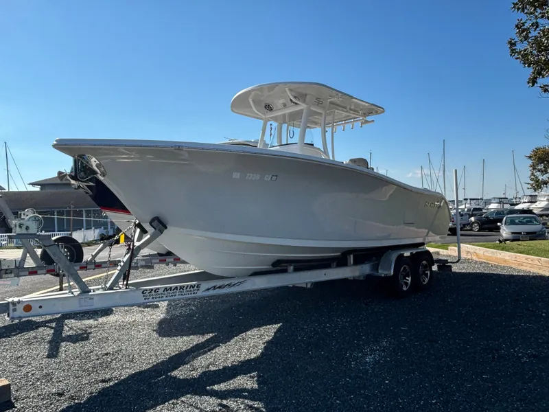 Slide: The Image of A 2021 Sea Pro 259 DLX boat on a trailer, ready for use. - 2