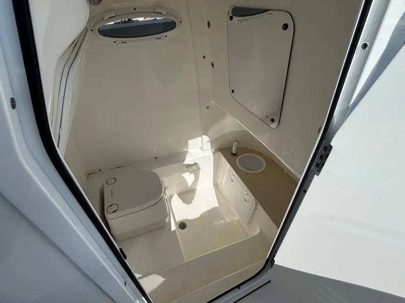 Slide: The Image of Interior view of a boat cabin with a toilet and sink. - 9