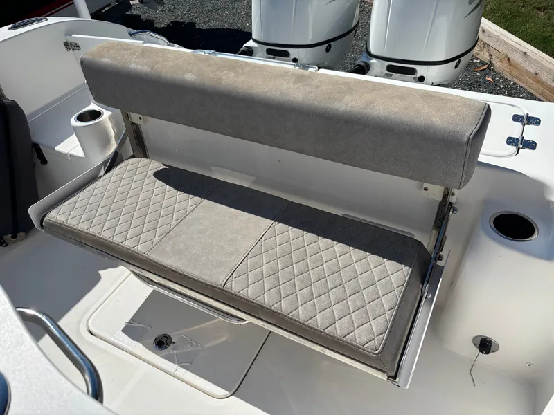 Slide: The Image of The rear bench seat of a 2021 Sea Pro 259 DLX with cushioned seating and backrest. - 12