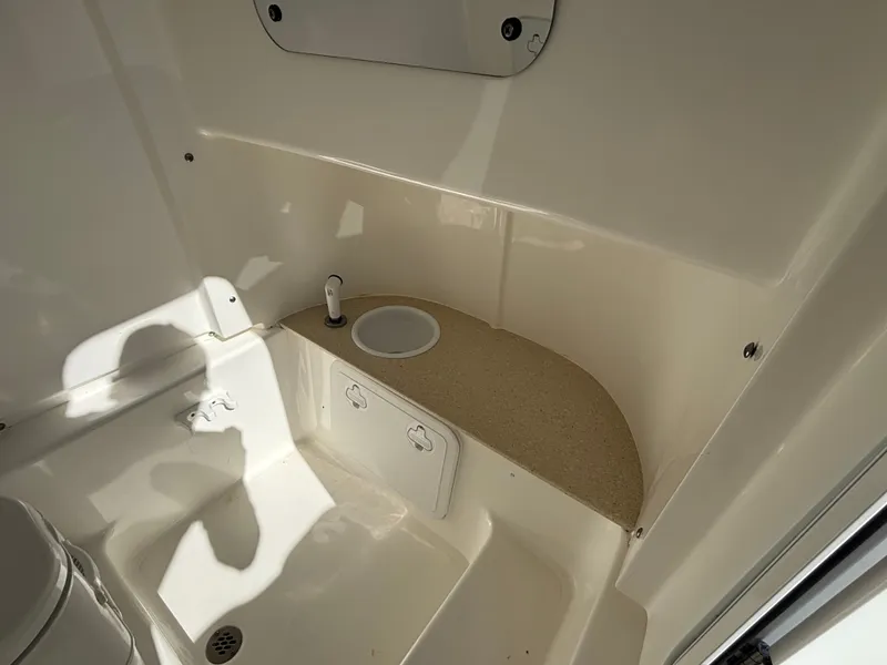 Slide: The Image of Interior view of a boat bathroom with a sink and storage space. - 11