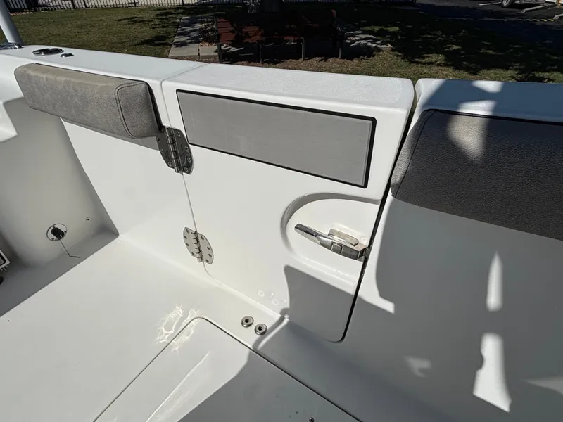 Slide: The Image of The image shows the cockpit of a 2021 Sea Pro 259 DLX boat with cushioned seating. - 16