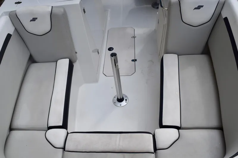Slide: The Image of 2024 Starcraft SVX 231 OB DH boat interior with cushioned seating and central pole. - 10