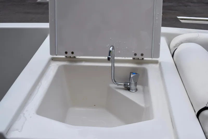 Slide: The Image of 2024 Starcraft SVX 231 OB DH boat sink with chrome faucet and white basin. - 11