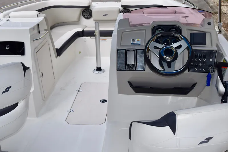 Slide: The Image of The image shows the cockpit of a 2024 Starcraft SVX 231 OB DH with modern controls and seating. - 9