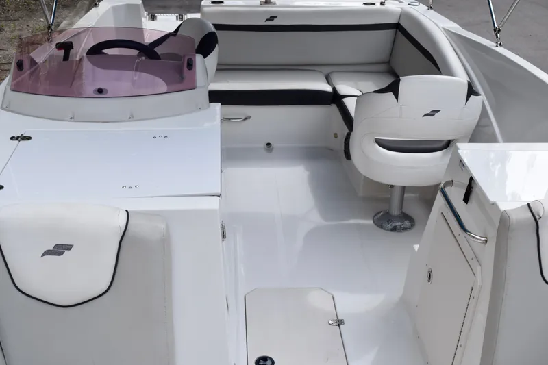 Slide: The Image of 2024 Starcraft SVX 231 OB DH boat interior with seating and steering wheel. - 6