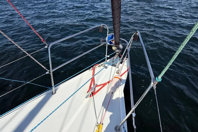 Slide: The Image of Bow of a 1994 J Boats J/120 sailboat with colorful ropes on the water. - 60
