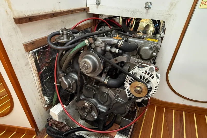 Slide: The Image of Engine compartment of a 1994 J Boats J/120 sailboat, showcasing mechanical components. - 78