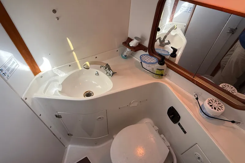 Slide: The Image of Bathroom interior of a 1994 J Boats J/120 yacht, featuring sink and toilet. - 46