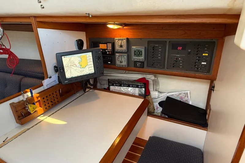 Slide: The Image of Navigation station of a 1994 J Boats J/120 with electronic equipment and charts. - 29