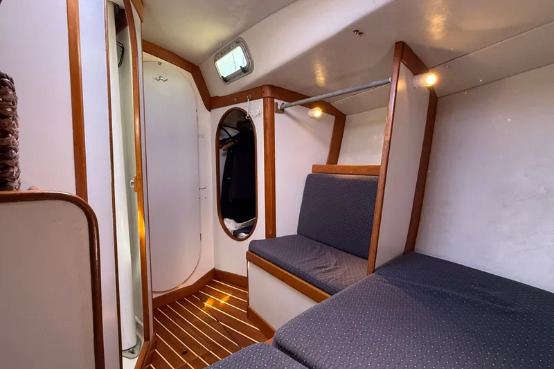 Slide: The Image of Interior of 1994 J Boats J/120 sailboat with wooden accents and cozy seating. - 41