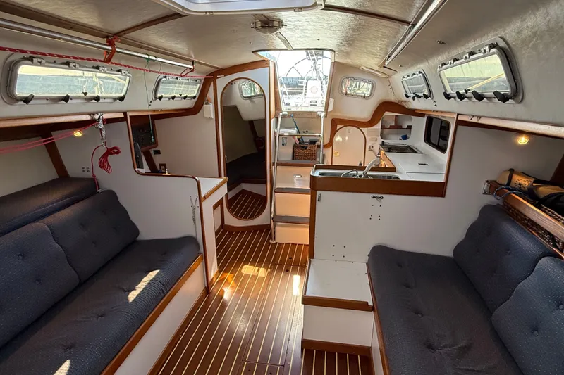 Slide: The Image of Interior of a 1994 J Boats J/120 sailboat with wood accents and cozy seating. - 14