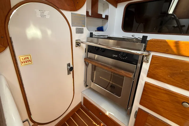 Slide: The Image of Interior of 1994 J Boats J/120 sailboat featuring a compact kitchen area. - 24