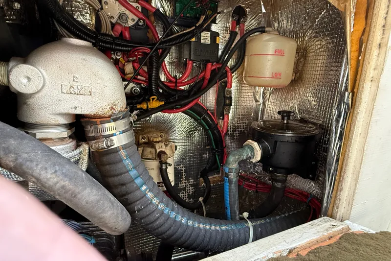 Slide: The Image of Engine compartment of a 1994 J Boats J/120, showing hoses and wiring. - 80