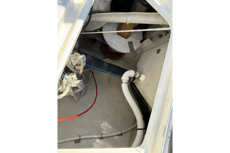 Slide: The Image of Interior view of a 1994 J Boats J/120 sailboat showing ropes and plumbing. - 83
