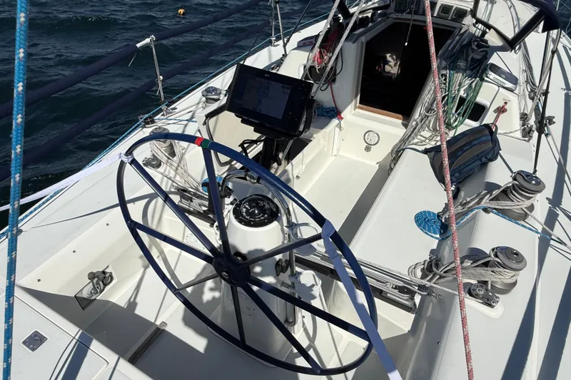 Slide: The Image of Cockpit of a 1994 J Boats J/120 sailboat with steering wheel and navigation equipment. - 50