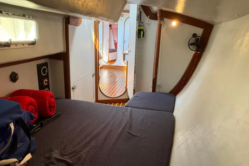 Slide: The Image of Cozy cabin interior of a 1994 J Boats J/120 sailboat with bed and wooden flooring. - 45
