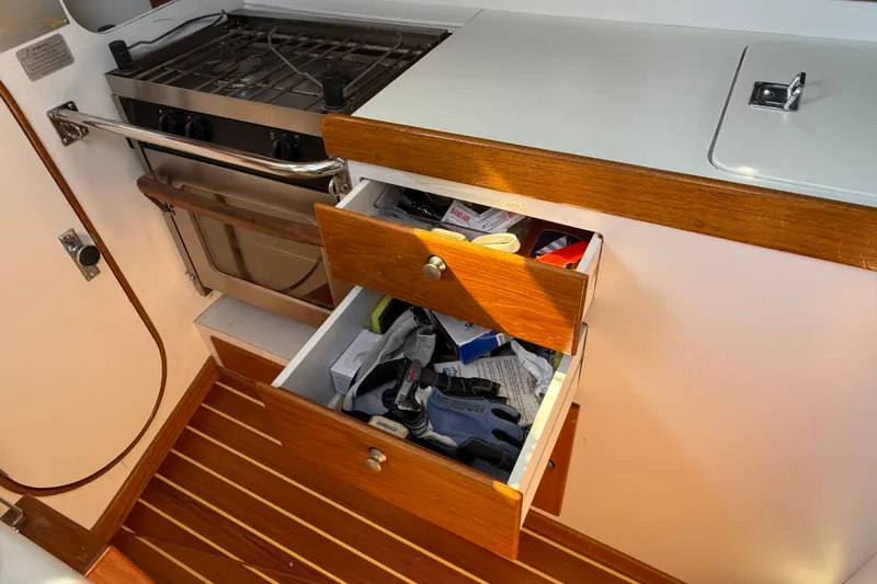 Slide: The Image of Interior of 1994 J Boats J/120 showing open drawers and stove in galley. - 27