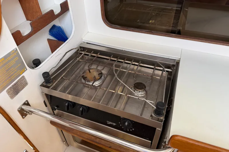 Slide: The Image of Stove in 1994 J Boats J/120 yacht galley, featuring a compact design. - 25