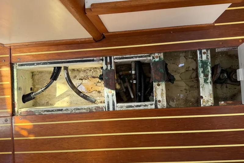 Slide: The Image of Interior view of a 1994 J Boats J/120, showing exposed underfloor compartments and wiring. - 87