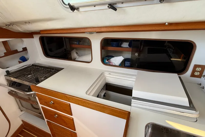 Slide: The Image of Interior of 1994 J Boats J/120 yacht kitchen with stove, storage, and countertop. - 22