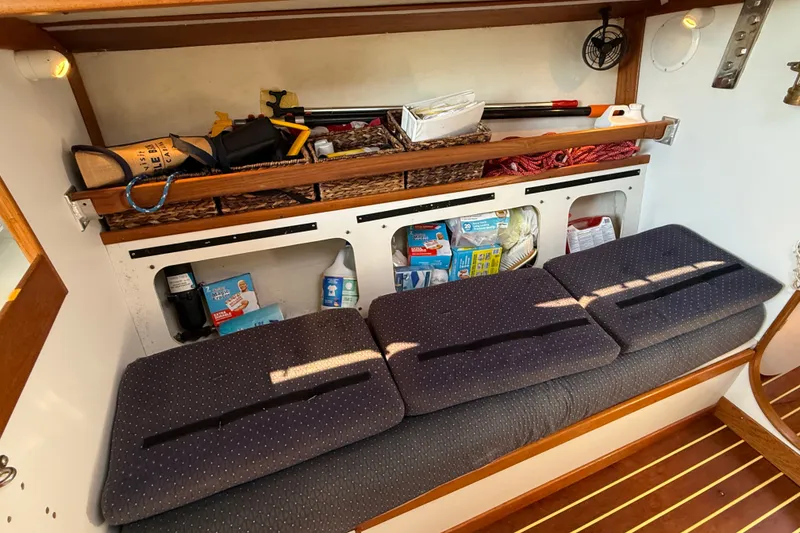 Slide: The Image of Interior of 1994 J Boats J/120 with storage shelves and cushioned seating. - 19