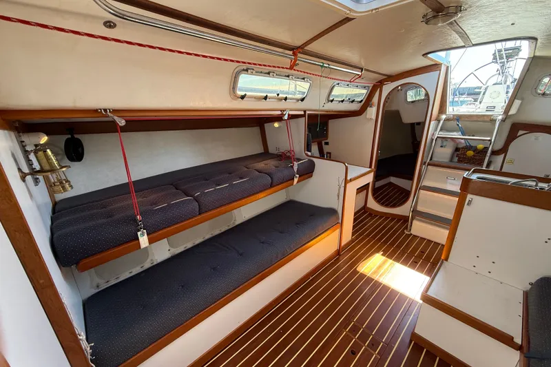 Slide: The Image of Interior of 1994 J Boats J/120 sailboat with wooden flooring and cozy seating. - 18