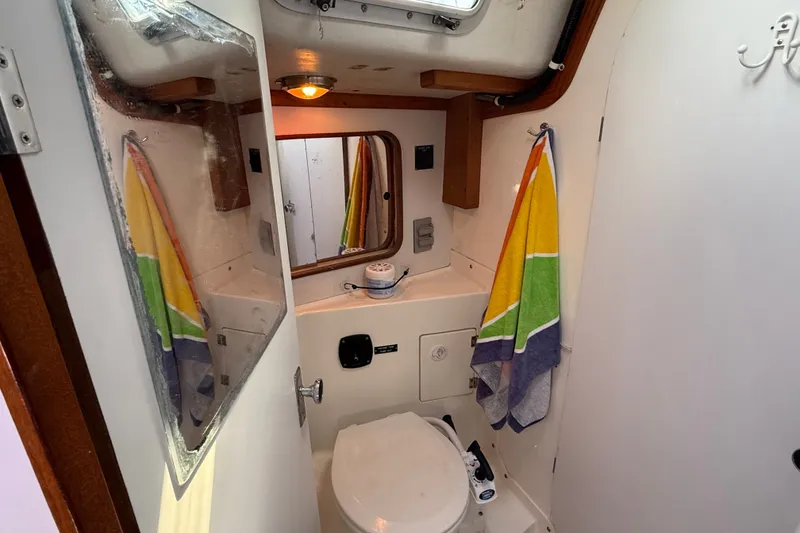 Slide: The Image of Compact bathroom in 1994 J Boats J/120 sailboat with colorful towel and mirror. - 47
