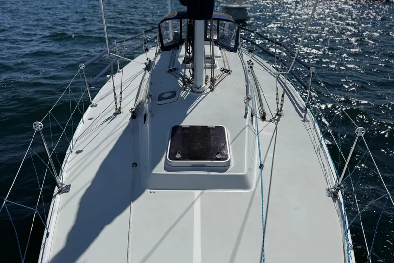 Slide: The Image of Deck view of a 1994 J Boats J/120 sailboat on sparkling water. - 61