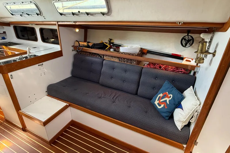 Slide: The Image of Cozy interior of 1994 J Boats J/120 sailboat with cushioned seating and nautical decor. - 15