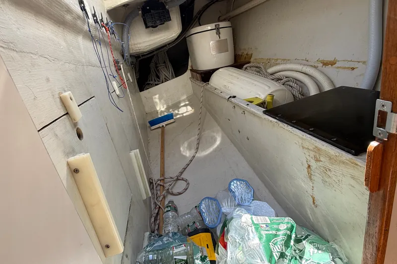 Slide: The Image of Interior of a 1994 J Boats J/120 sailboat with storage items and equipment. - 84