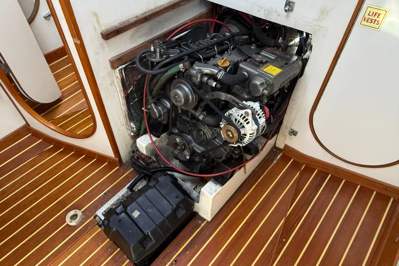 Slide: The Image of Engine compartment of a 1994 J Boats J/120 sailboat, showcasing detailed mechanics. - 76