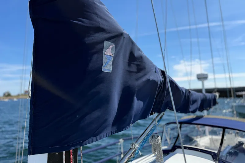 Slide: The Image of Sailboat J/120 from 1994 with covered mainsail, docked on a sunny day. - 62