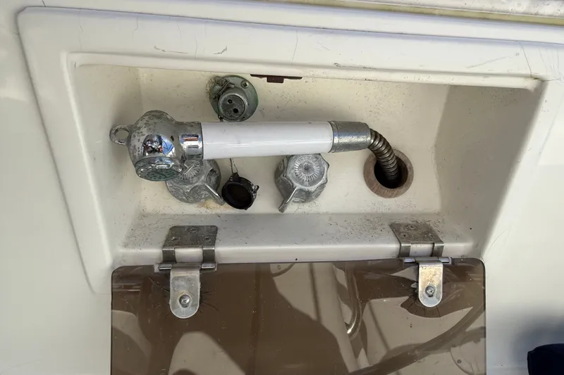 Slide: The Image of Close-up of a 1994 J Boats J/120 deck fitting with hose and latch. - 71