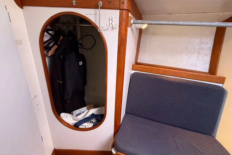 Slide: The Image of Interior of 1994 J Boats J/120 sailboat showing closet and seating area. - 42