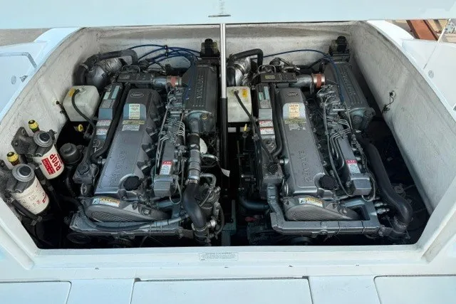 Slide: The Image of Twin engines in a 2009 Spectre 37 boat, showcasing detailed mechanical components. - 23
