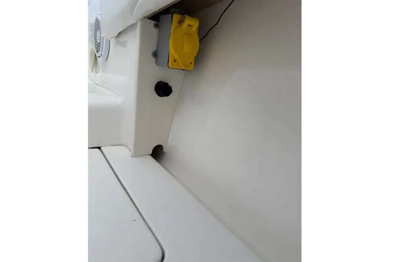 Slide: The Image of Interior view of a 2009 Spectre 37 boat, featuring a yellow electrical outlet. - 33