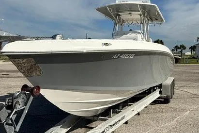 Slide: The Image of 2009 Spectre 37 boat on trailer, parked outdoors under clear sky. - 4