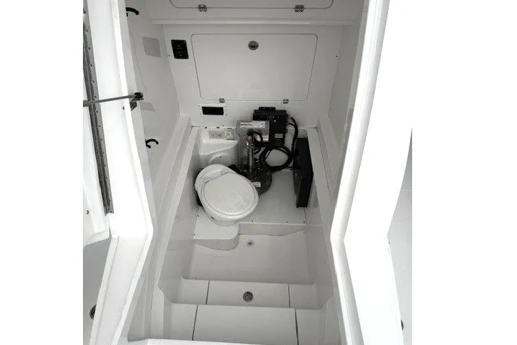 Slide: The Image of 2009 Spectre 37 boat interior with compact marine toilet and storage area. - 21