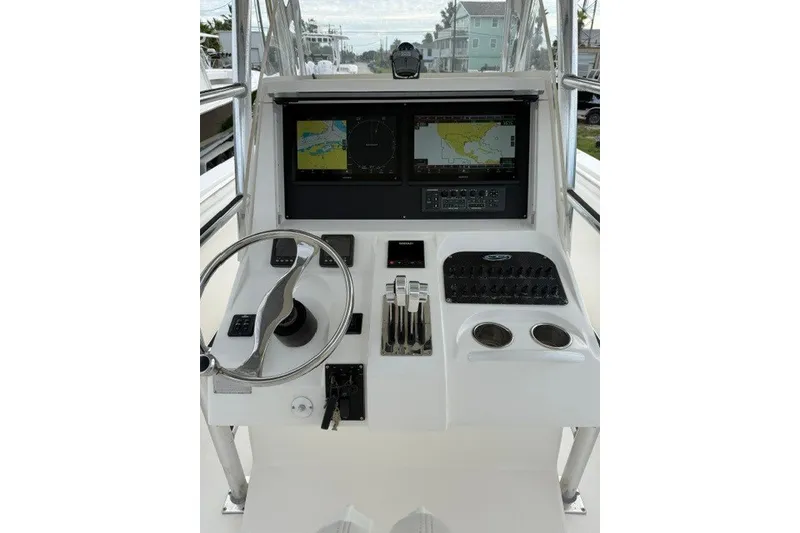 Slide: The Image of Spectre 37 boat dashboard with steering wheel, controls, and navigation screens, 2009 model. - 9