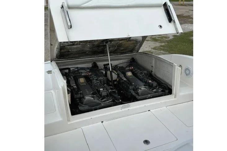 Slide: The Image of Open engine compartment of a 2009 Spectre 37 boat, showcasing dual engines. - 24
