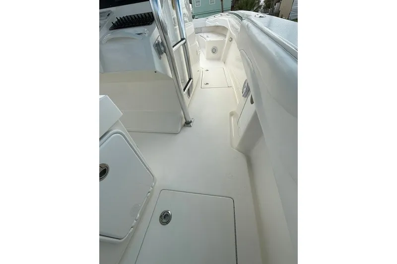 Slide: The Image of 2009 Spectre 37 boat interior with white deck and storage compartments. - 22