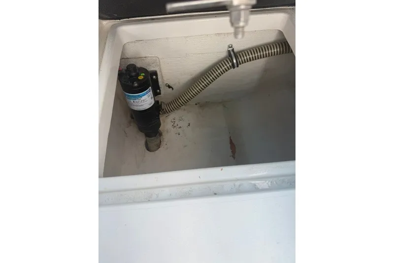 Slide: The Image of Bilge pump in a 2009 Spectre 37 boat compartment with hose connection. - 26
