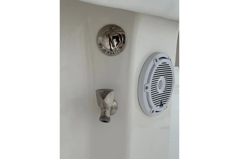 Slide: The Image of Boat deck with waste outlet, faucet, and speaker on a 2009 Spectre 37 model. - 34
