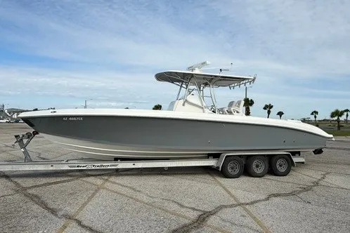 Slide: The Image of Spectre 37 boat on trailer, 2009 model, parked outdoors under a cloudy sky. - 2