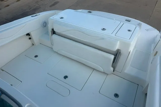 Slide: The Image of Spacious deck of a 2009 Spectre 37 boat with white seating and storage compartments. - 17