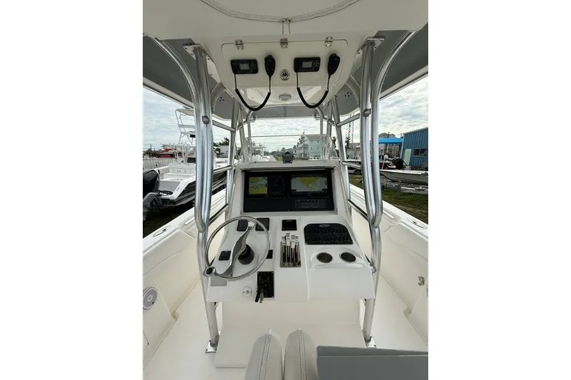 Slide: The Image of 2009 Spectre 37 boat cockpit with steering wheel, navigation screens, and control panel. - 8