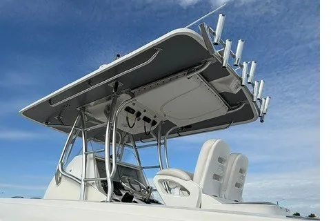 Slide: The Image of 2009 Spectre 37 boat with T-top and rod holders against blue sky. - 6