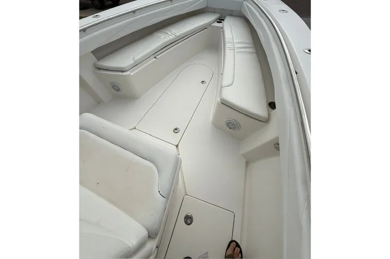 Slide: The Image of Spacious interior of 2009 Spectre 37 boat with white seating and storage compartments. - 20