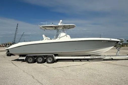 Slide: The Image of 2009 Spectre 37 boat on trailer under clear sky. - 1