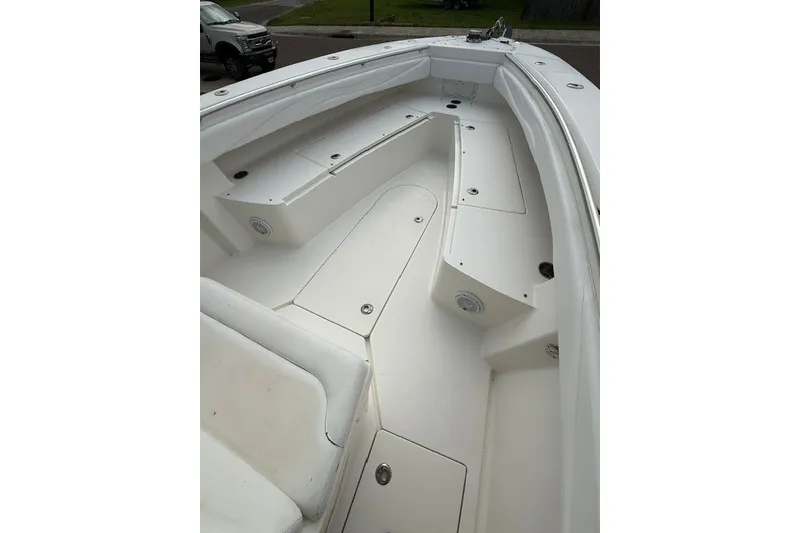 Slide: The Image of 2009 Spectre 37 boat interior, featuring spacious white deck and seating area. - 19